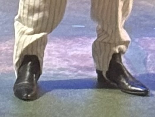 a close up of the hem of the pants featuring a stirrup going under the shoe