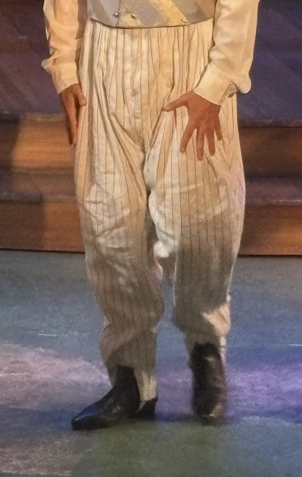 a man wearing pleated regency pants, front view