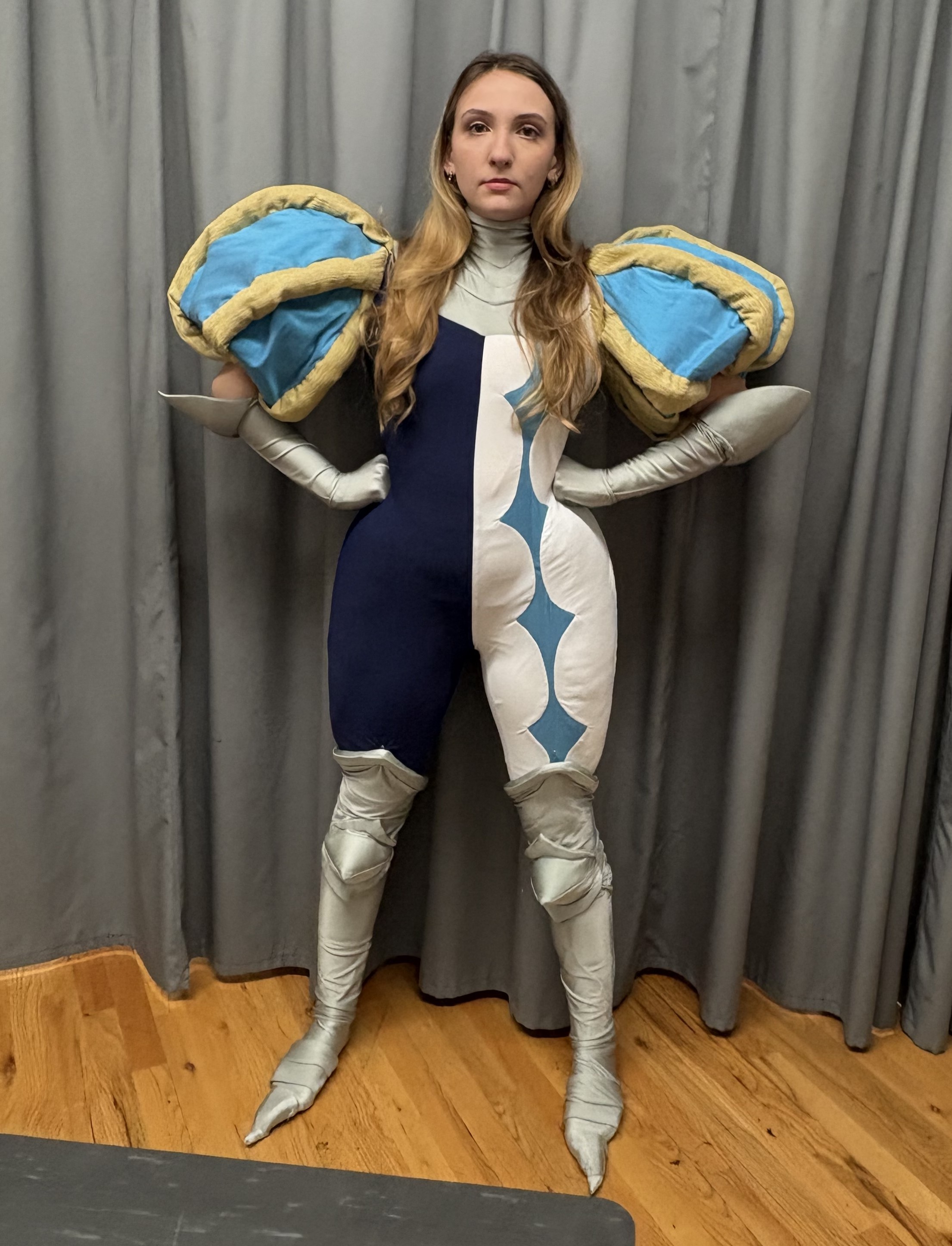 A split color, navy and white unitard with big puff sleeves