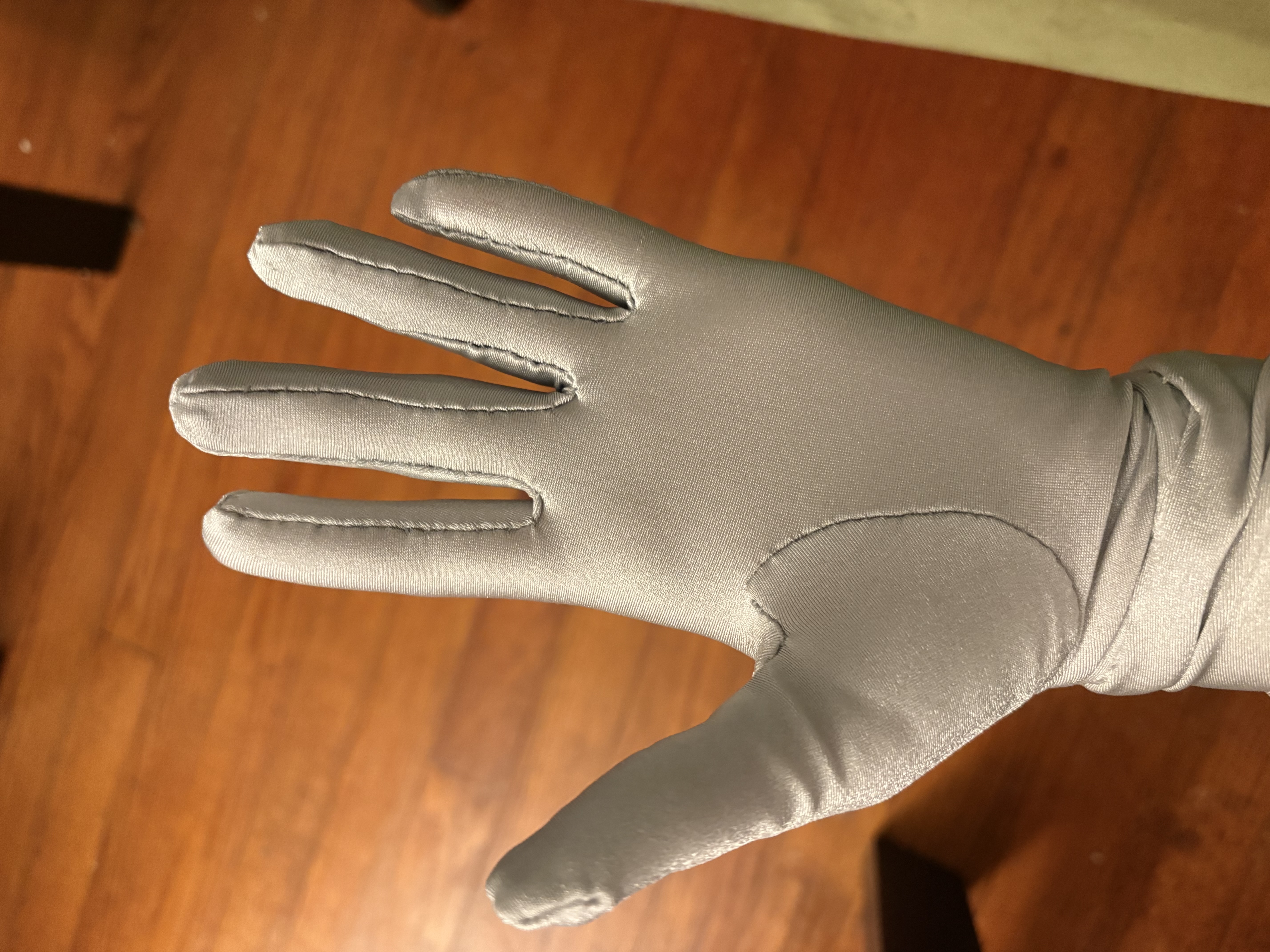 A closeup of a silver gloved hand