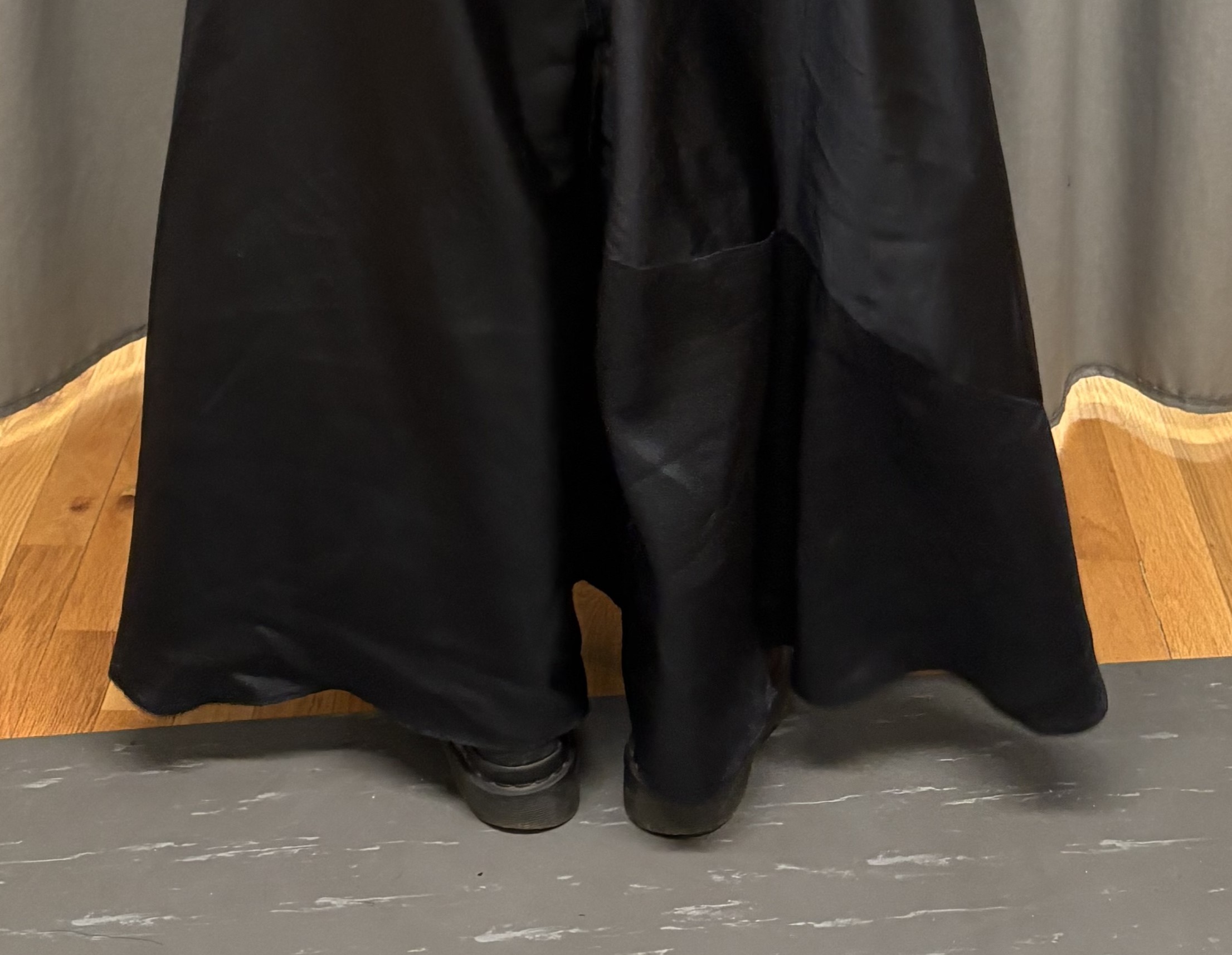 A closeup 	of the hem, featuring a seam extending the lenght