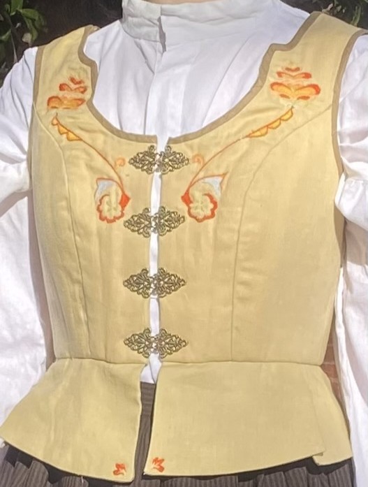 A yellow bodice with orange floral embroidery