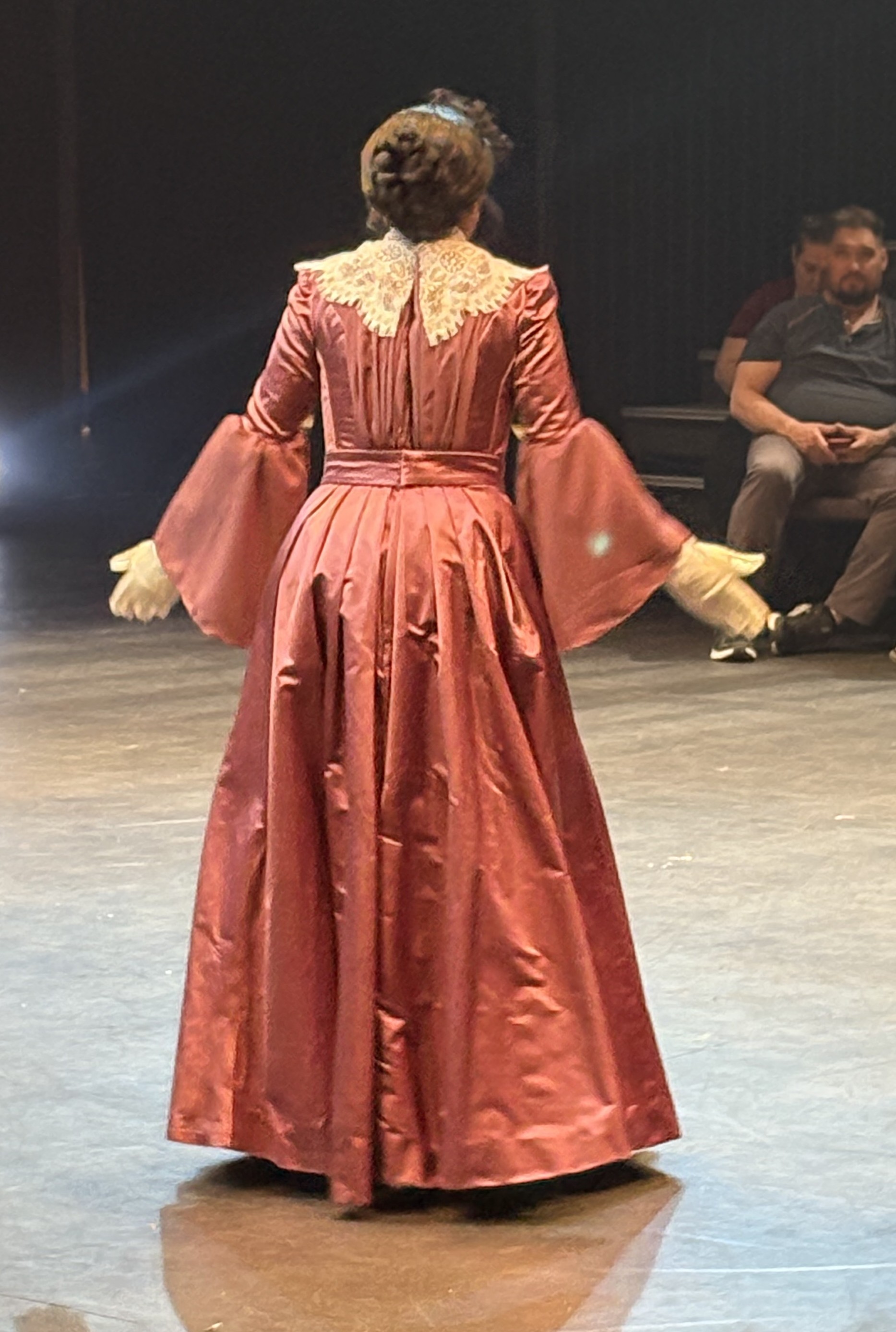 woman in a purple edwardian dress, back view