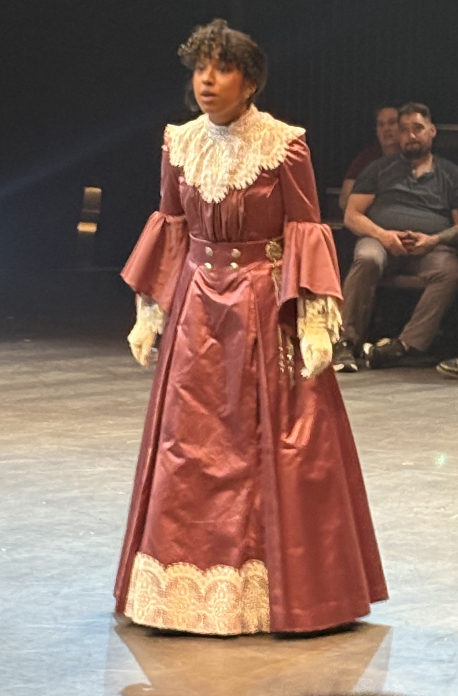 woman in a purple edwardian dress, front view