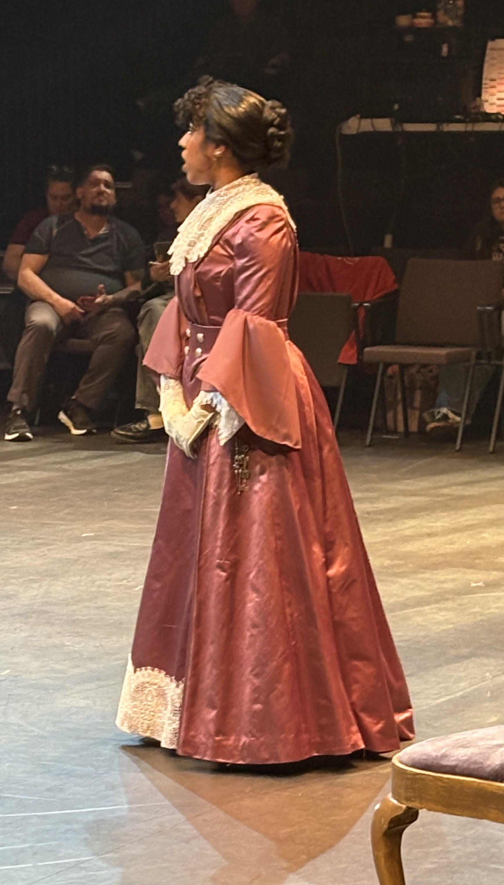 woman in a purple edwardian dress, side view