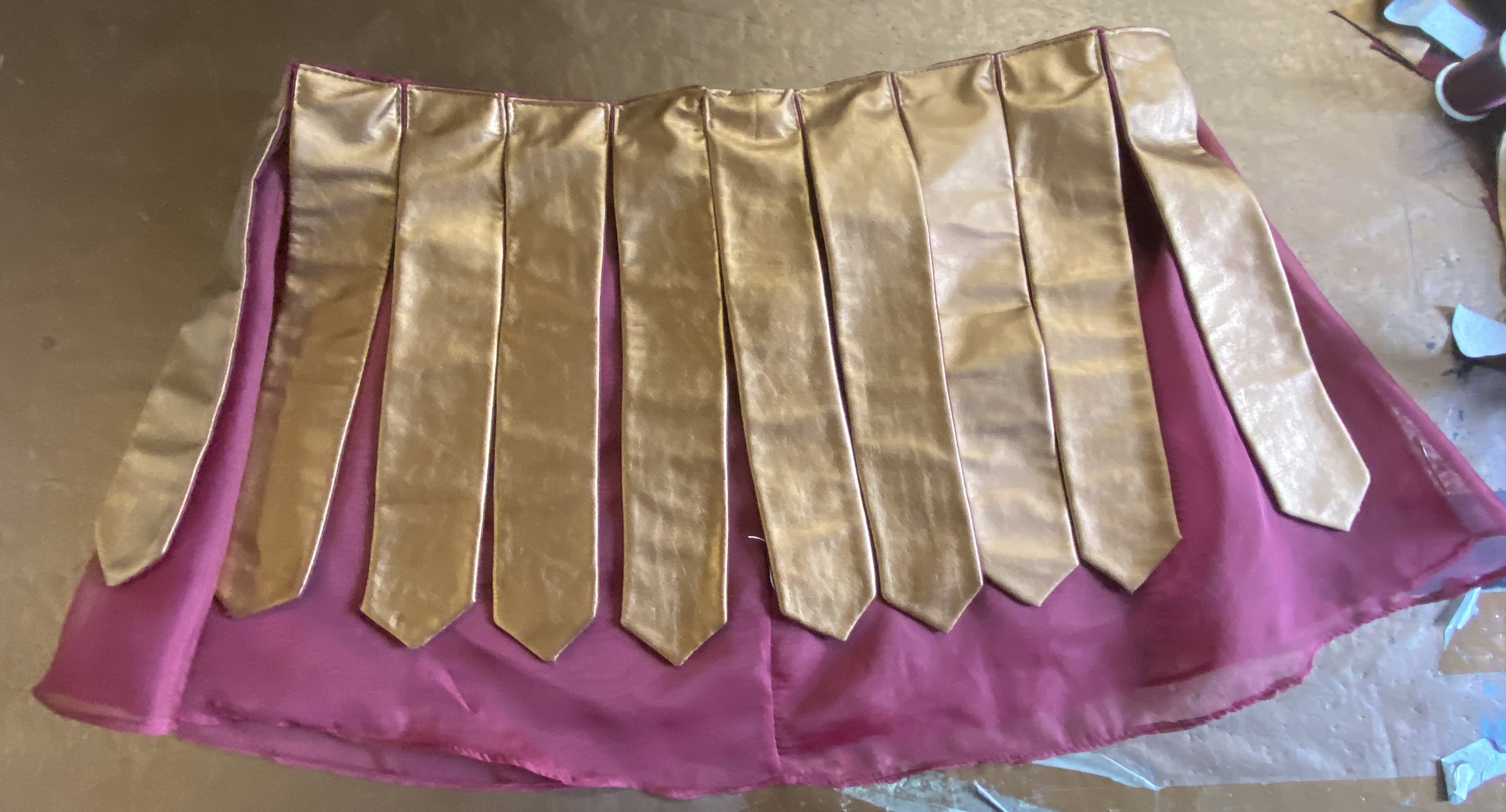 A sheer red skirt with pleather tabs