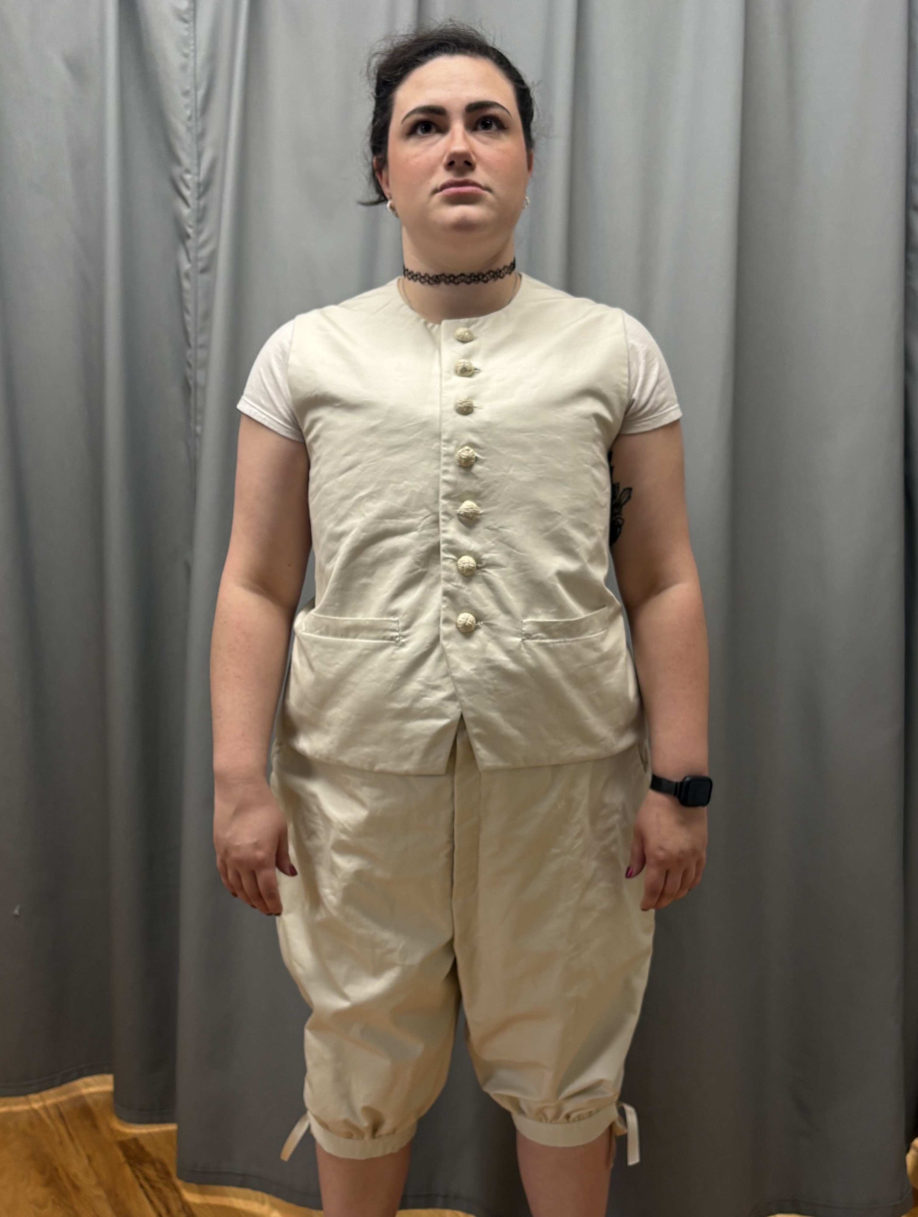 A beige georgian vest and a pair of matching breeches