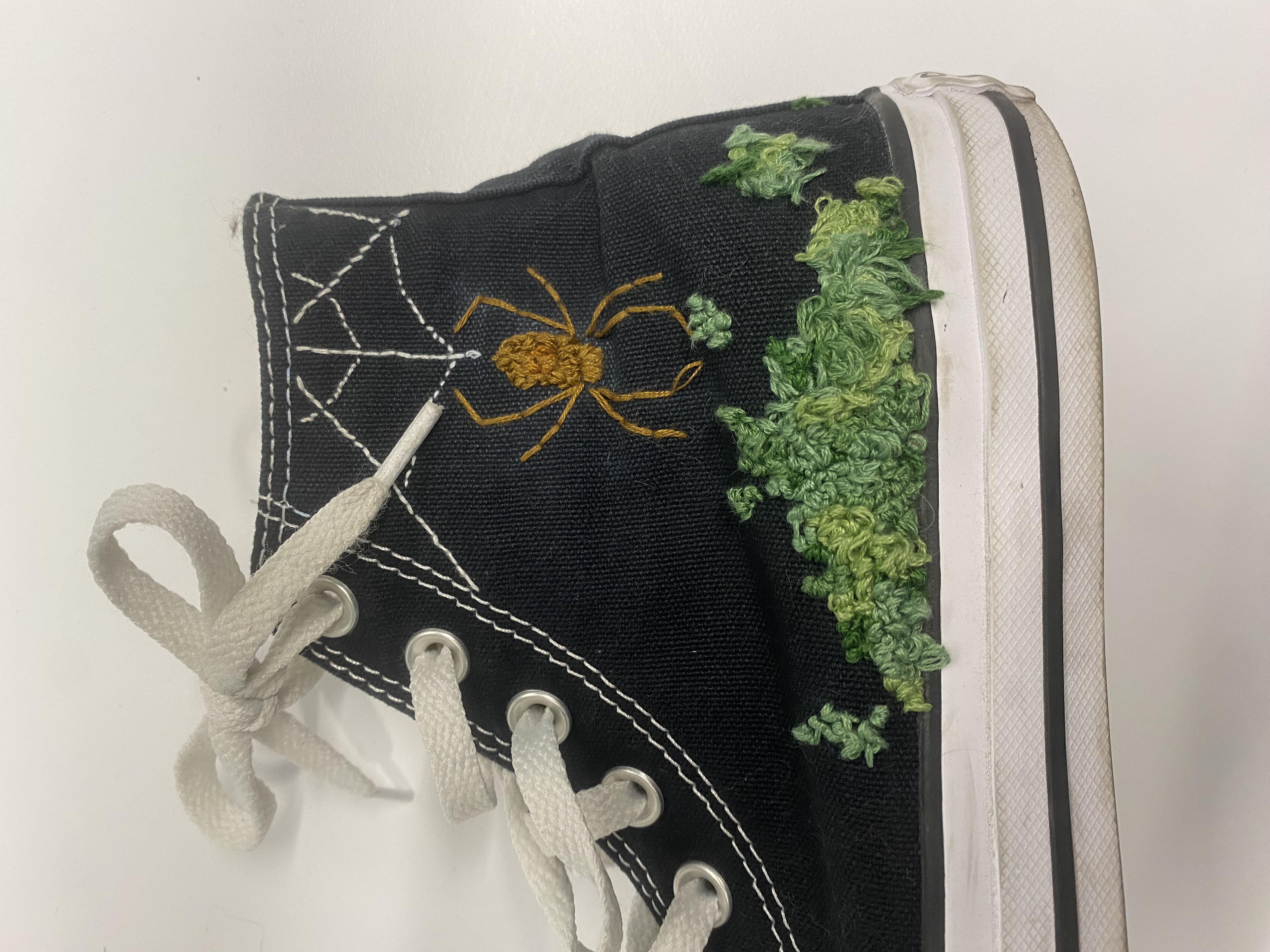 an embroidered spider and web
