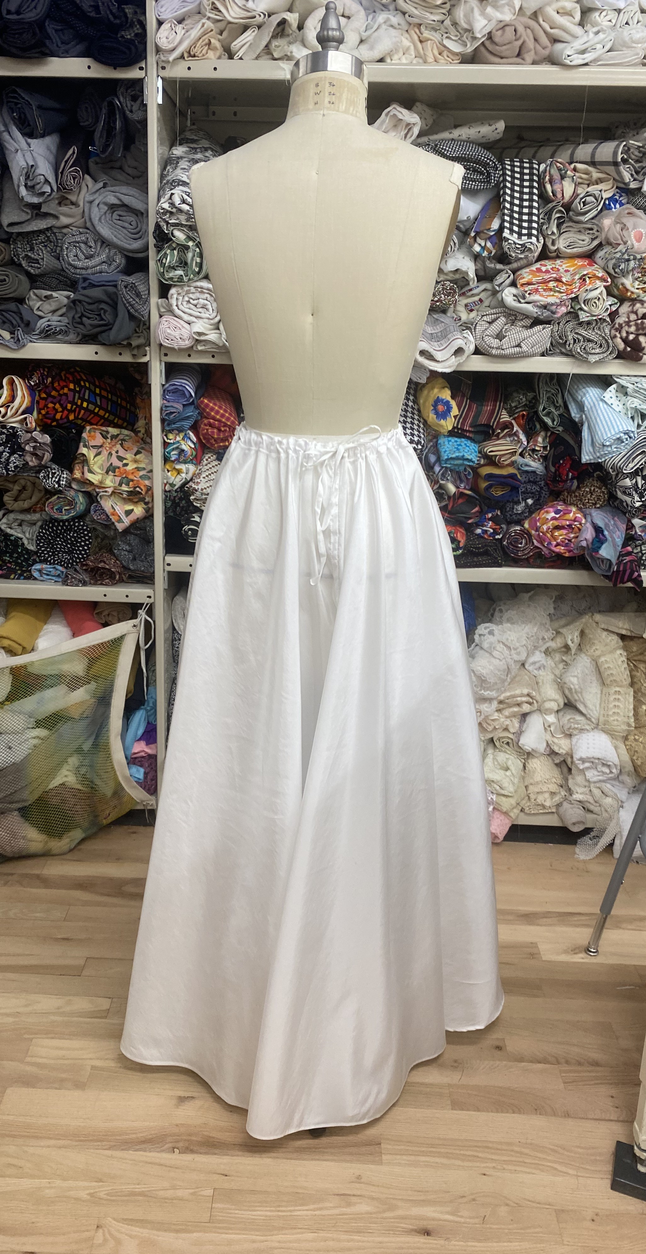 A closeup 	of the hem, featuring a seam extending the lenght