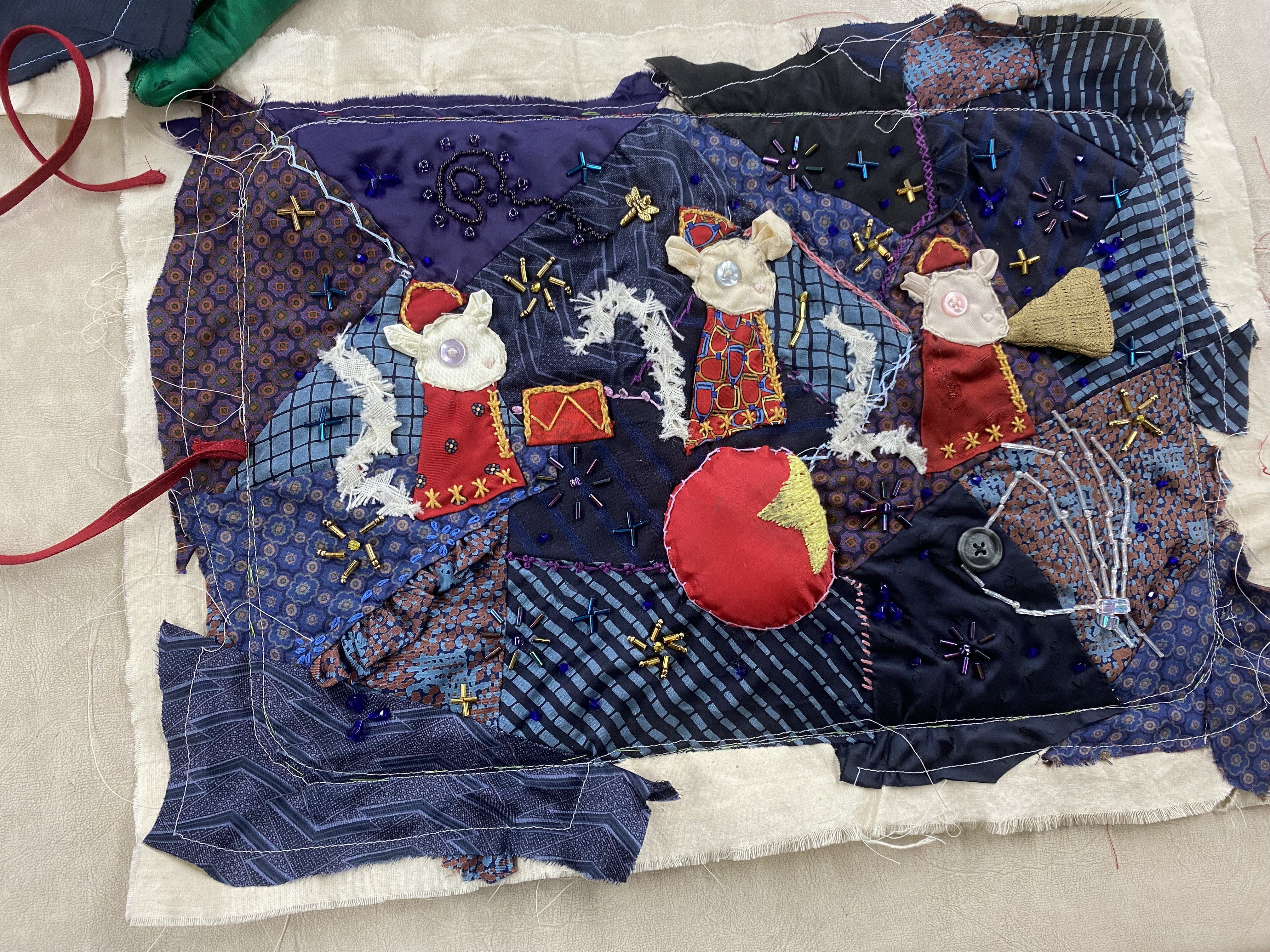 The front of the quilt. the quilting, embroidery, and beading are done but the edges are unfinished